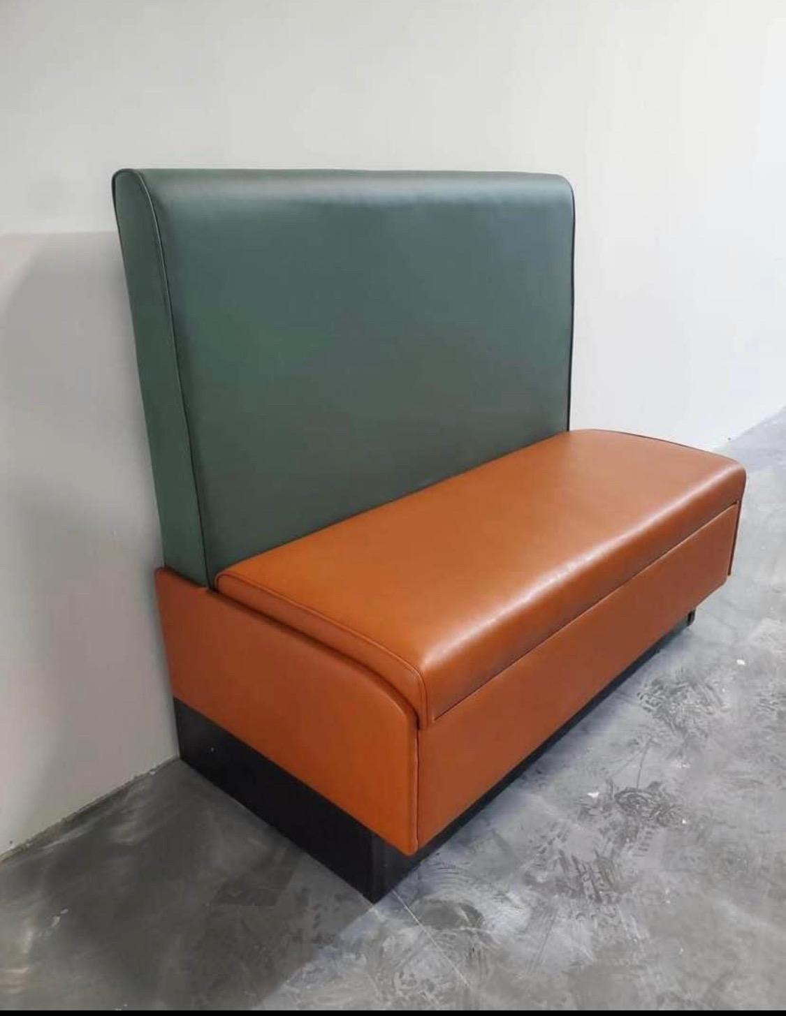 Completed restaurant bench with a green vinyl backrest and rust-orange vinyl seat