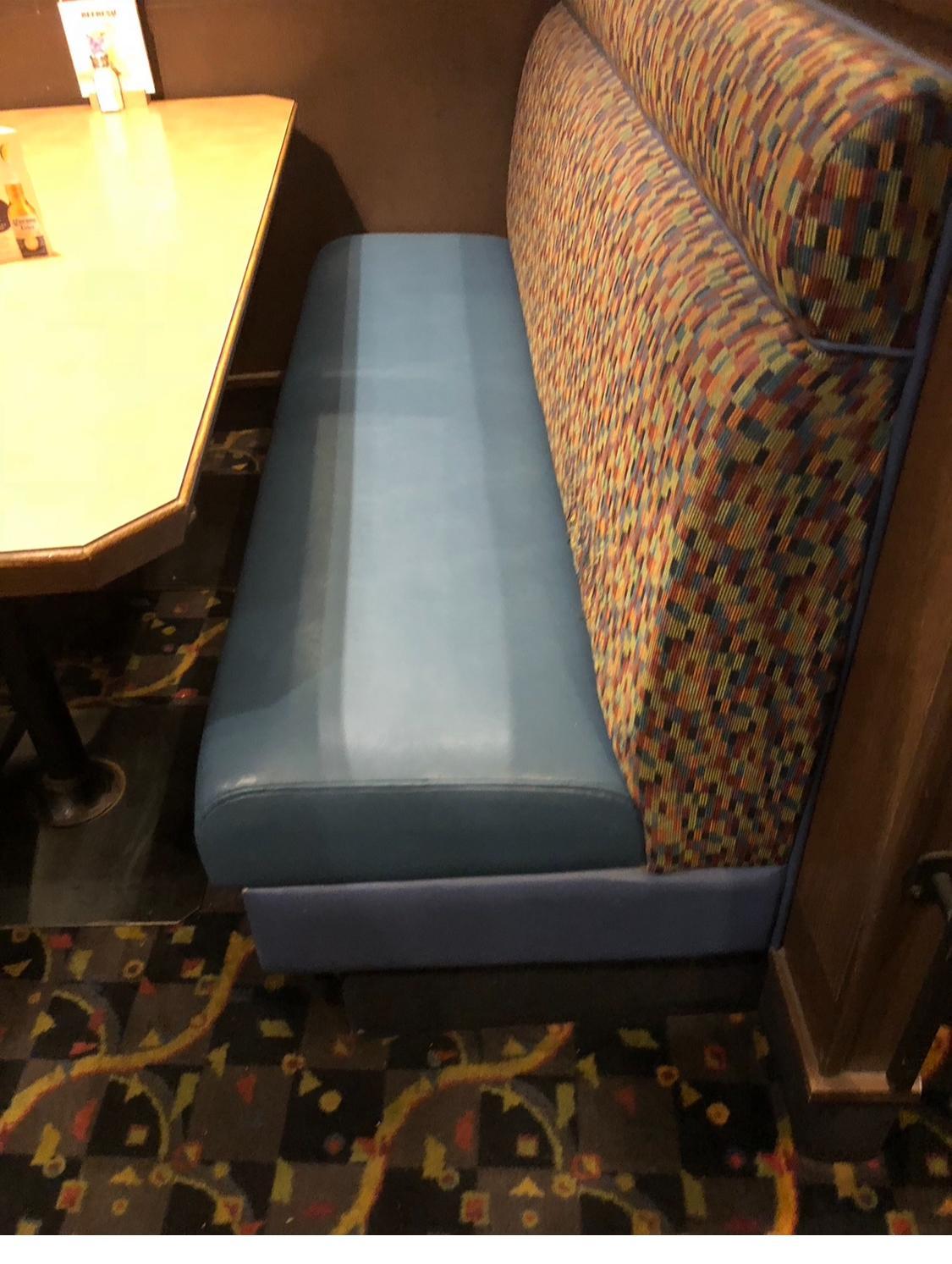 Restaurant booth bench with a blue vinyl seat and patterned fabric backrest