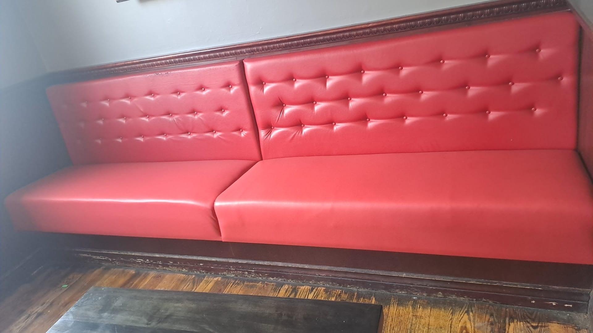 Red vinyl banquette seating with diamond button-tufting