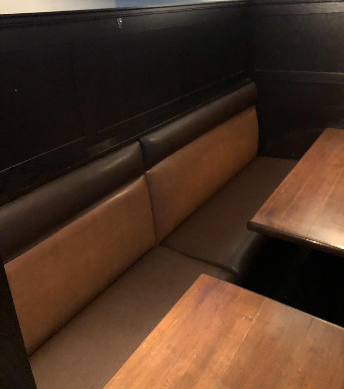 Restaurant booth bench reupholstered in two-tone tan and brown vinyl