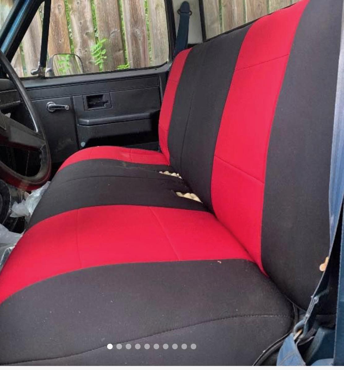 Vehicle bench seat with a red and black upholstered seat cover